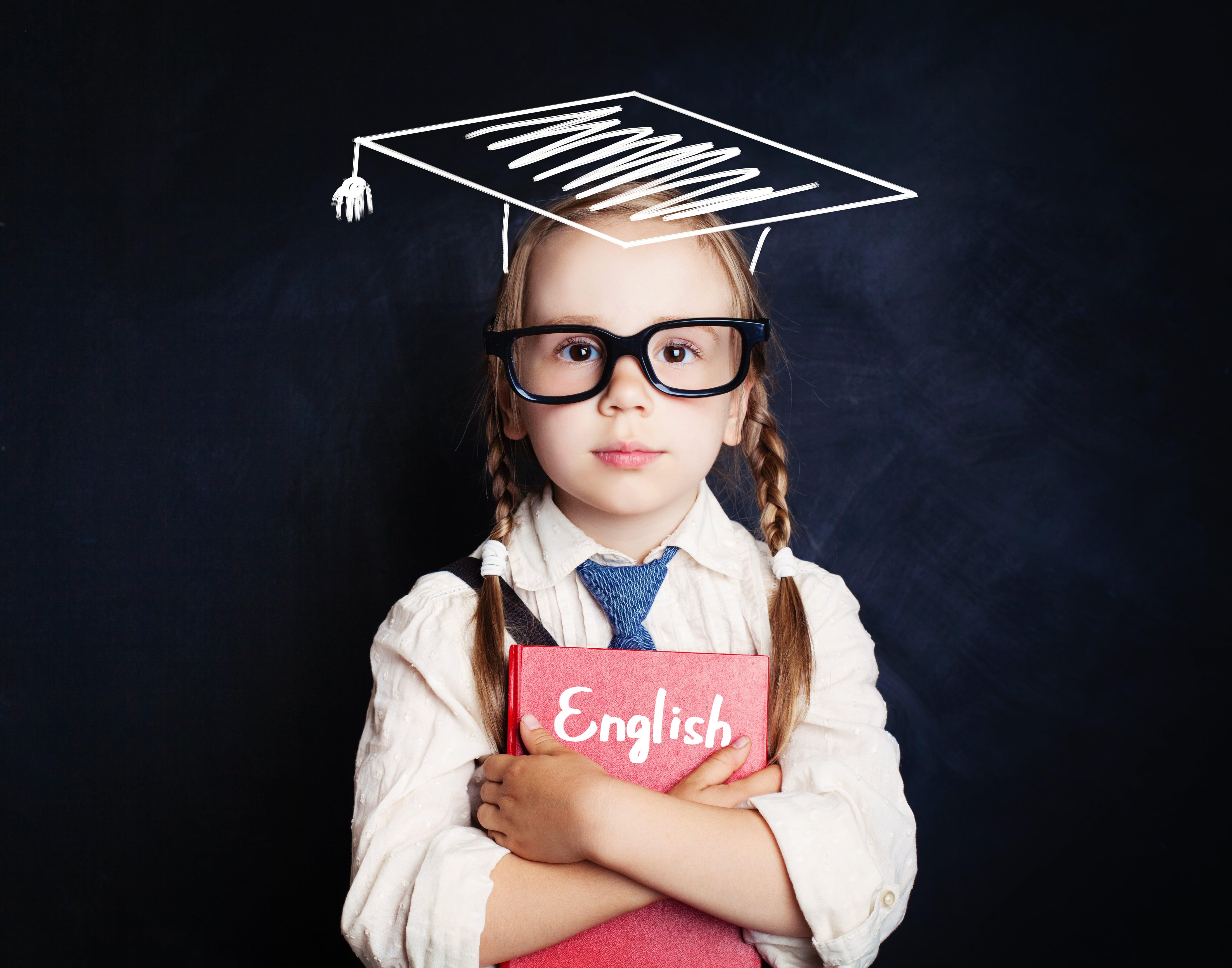 3rd Grader holding an English book on her hands.