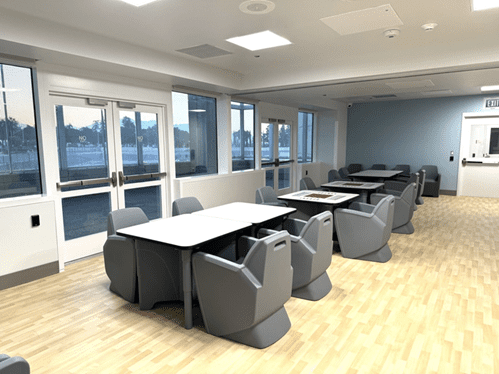 ARMC Health Unit room with wood floors, tables and chairs